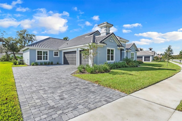 view of front of home with a front yard and a garage