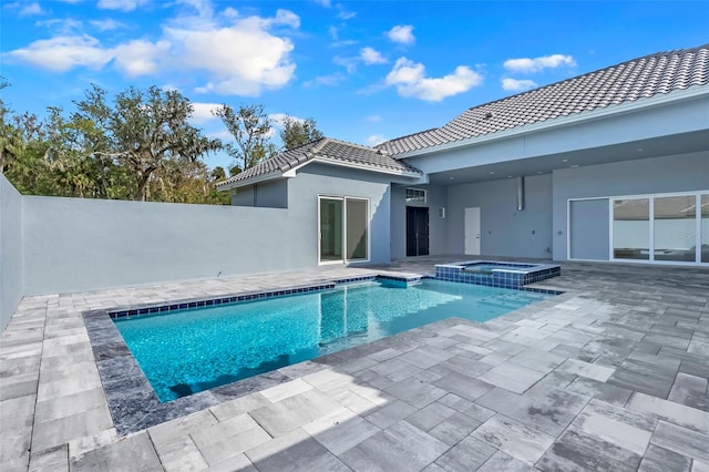 view of pool featuring a patio and an in ground hot tub