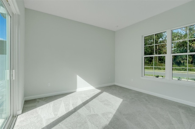 spare room featuring light colored carpet