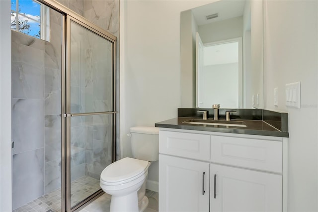 bathroom with vanity, tile patterned flooring, toilet, and walk in shower