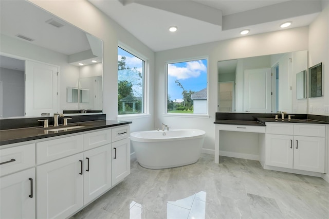 bathroom with vanity and a bath