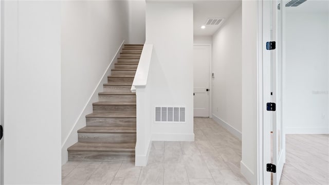 stairs featuring recessed lighting, visible vents, and baseboards