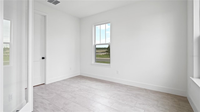 spare room featuring baseboards and visible vents