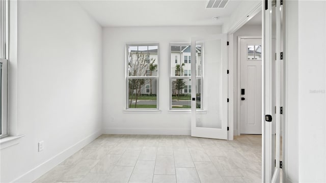 doorway to outside with visible vents and baseboards