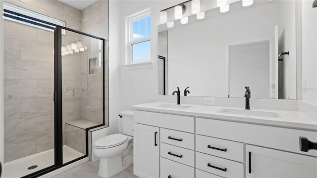 bathroom with double vanity, a sink, toilet, and a shower stall