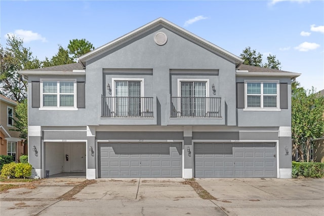 view of property with a balcony and a garage