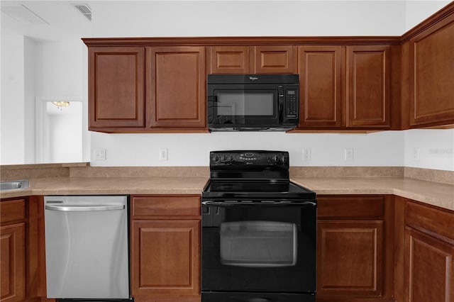 kitchen featuring black appliances, light countertops, and brown cabinets