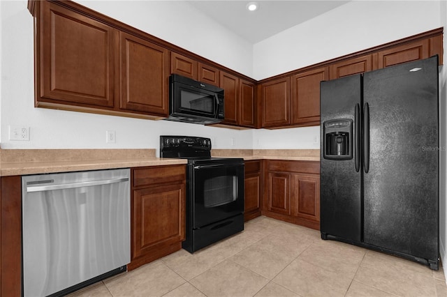 kitchen featuring black appliances, light tile patterned floors, light countertops, and recessed lighting