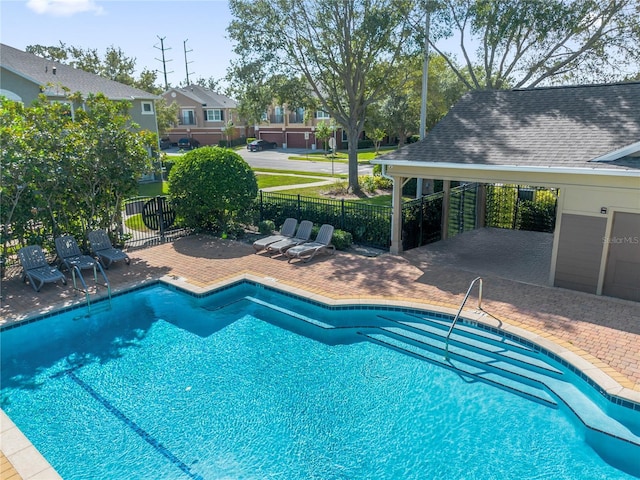 pool featuring a patio area, a residential view, and fence