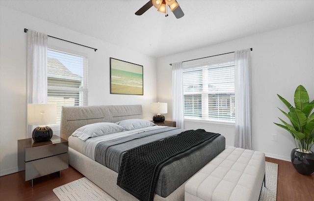 3010 San Jacinto Cir Unit 3010, Sanford, FL 32771 - bedroom featuring wood finished floors, multiple windows, a ceiling fan, and baseboards