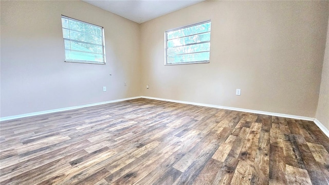 unfurnished room with hardwood / wood-style flooring