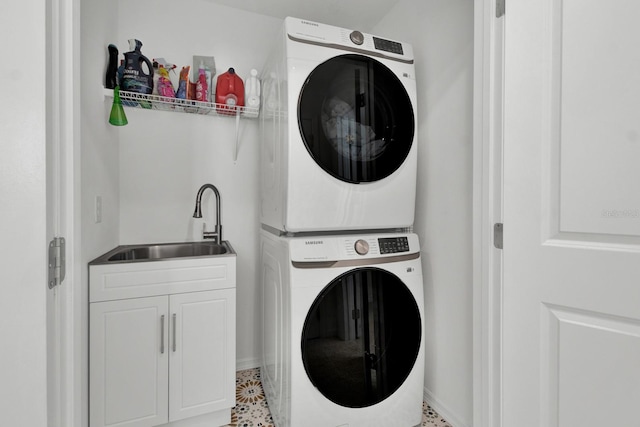 washroom with stacked washer and dryer and sink