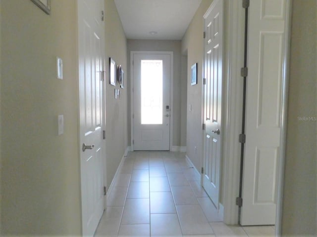 entryway with light tile patterned flooring