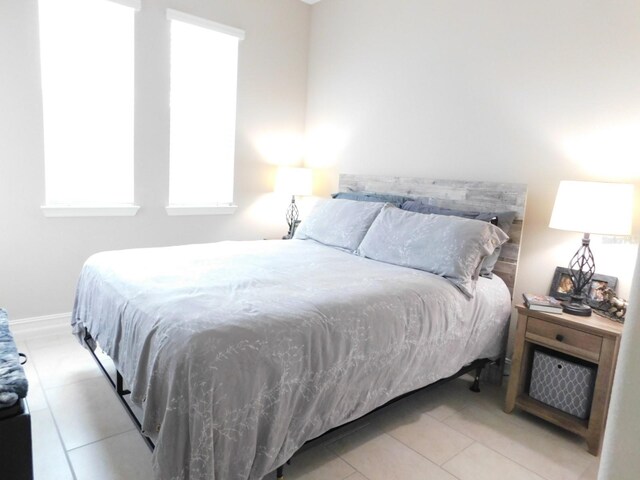 bedroom with light tile patterned flooring