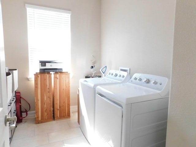 washroom featuring separate washer and dryer and light tile patterned floors