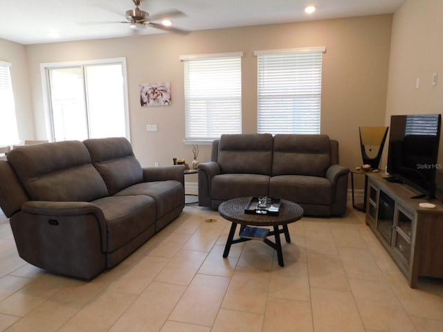 living room with ceiling fan, a healthy amount of sunlight, and light tile patterned floors