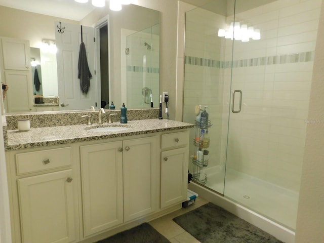 bathroom with vanity, an enclosed shower, and tile patterned floors