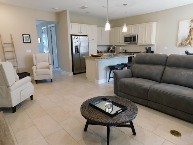 living room with sink and light tile patterned floors