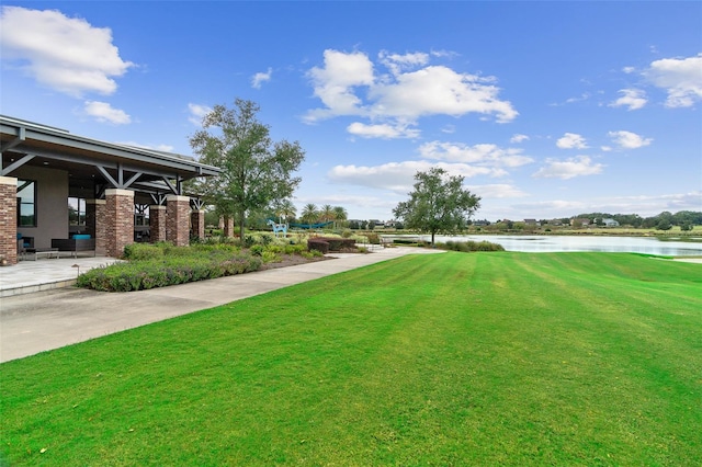 view of yard featuring a patio area and a water view