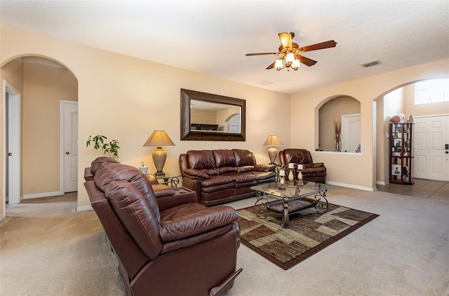 carpeted living room with ceiling fan