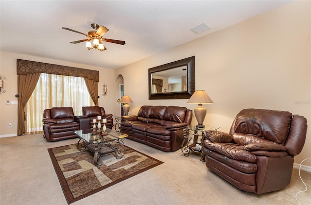 carpeted living room with ceiling fan