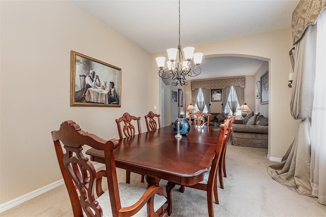 dining room featuring a chandelier and carpet flooring