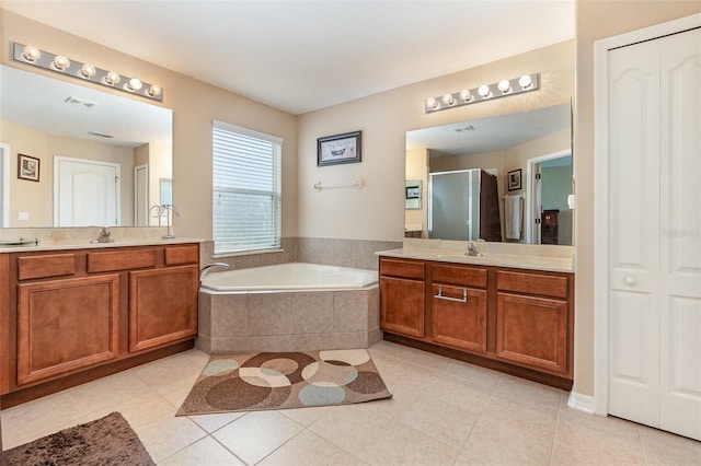 bathroom with vanity, shower with separate bathtub, and tile patterned floors