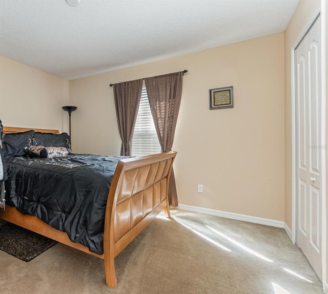 carpeted bedroom featuring a textured ceiling