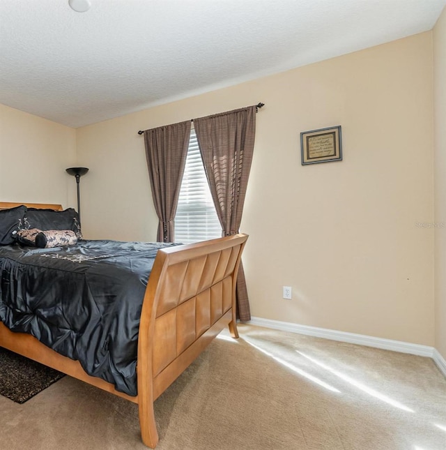 bedroom with carpet and a textured ceiling