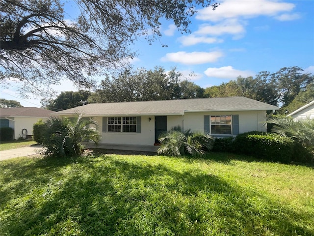 ranch-style home with a front lawn