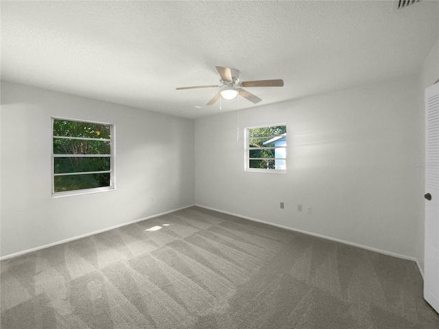 carpeted empty room with a textured ceiling and ceiling fan