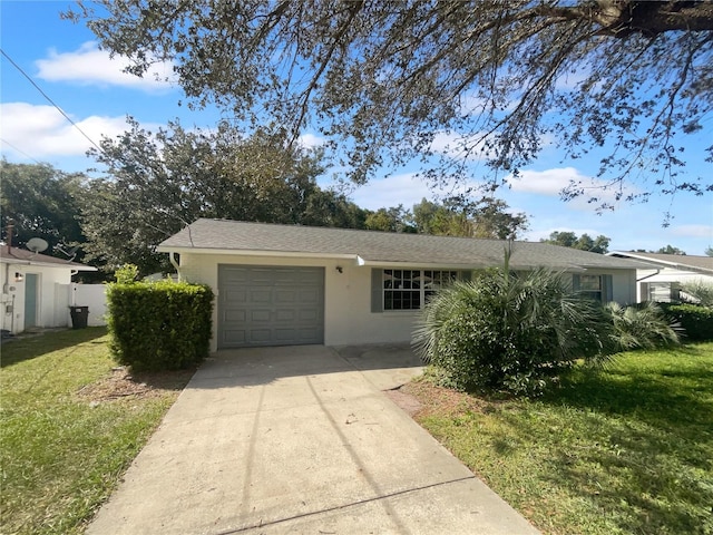 view of front of property with a front lawn and a garage