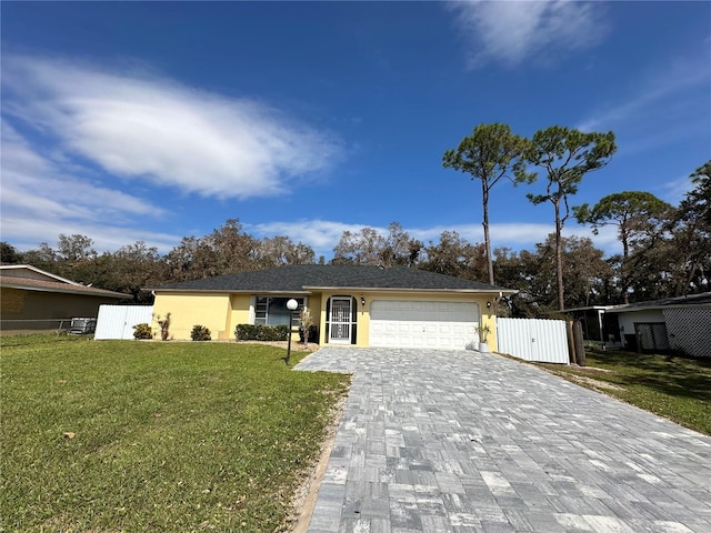 single story home featuring a front lawn and a garage