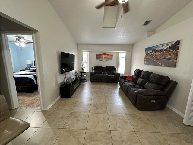 tiled living room with vaulted ceiling and ceiling fan