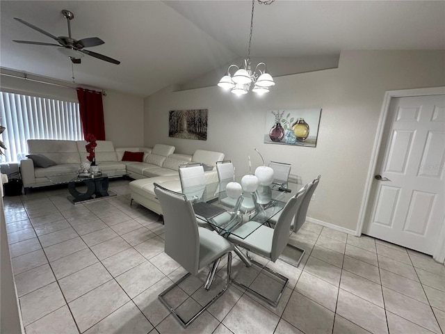 tiled dining space featuring lofted ceiling and ceiling fan with notable chandelier