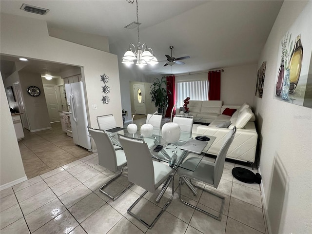 dining area featuring light tile patterned flooring and ceiling fan with notable chandelier