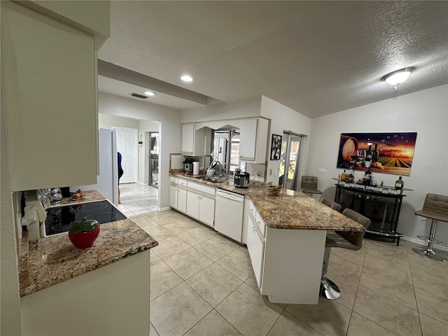 kitchen featuring dishwasher, kitchen peninsula, sink, white cabinetry, and a textured ceiling