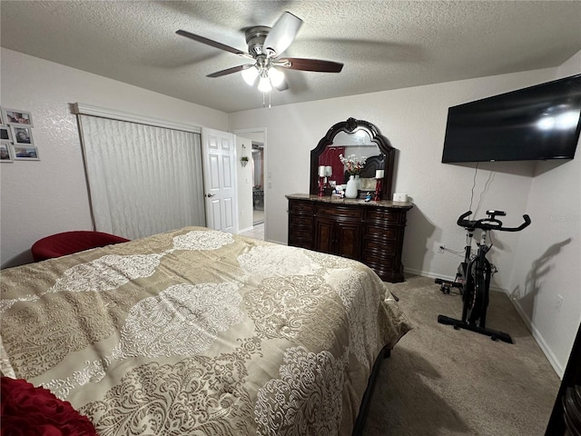 carpeted bedroom with a textured ceiling and ceiling fan