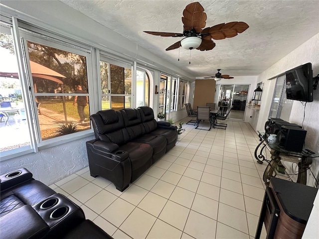 sunroom / solarium featuring ceiling fan