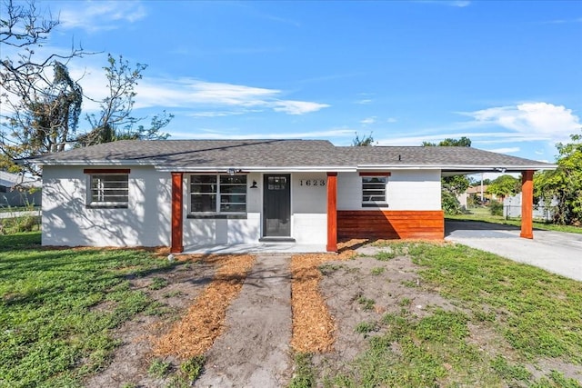 single story home featuring a front yard and a carport