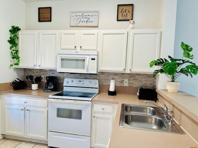 kitchen with sink, light tile patterned flooring, white cabinetry, white appliances, and tasteful backsplash