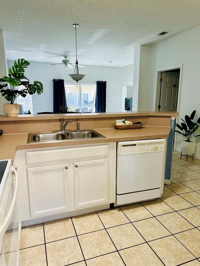 kitchen featuring white appliances, a textured ceiling, sink, and white cabinets