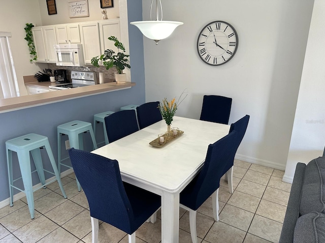 dining area with light tile patterned floors