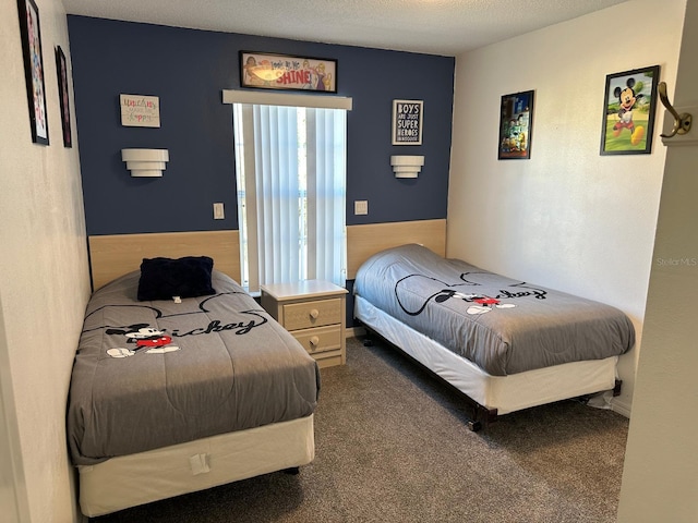 bedroom with a textured ceiling and carpet