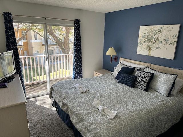 bedroom featuring a textured ceiling, access to exterior, and carpet flooring