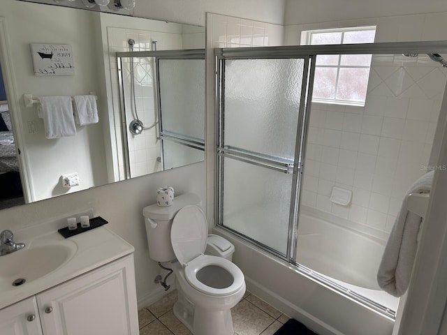 full bathroom featuring vanity, enclosed tub / shower combo, toilet, and tile patterned flooring