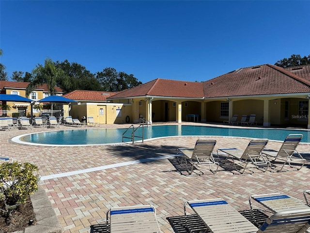 view of swimming pool featuring a patio area