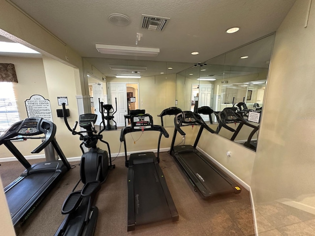 workout area featuring a textured ceiling