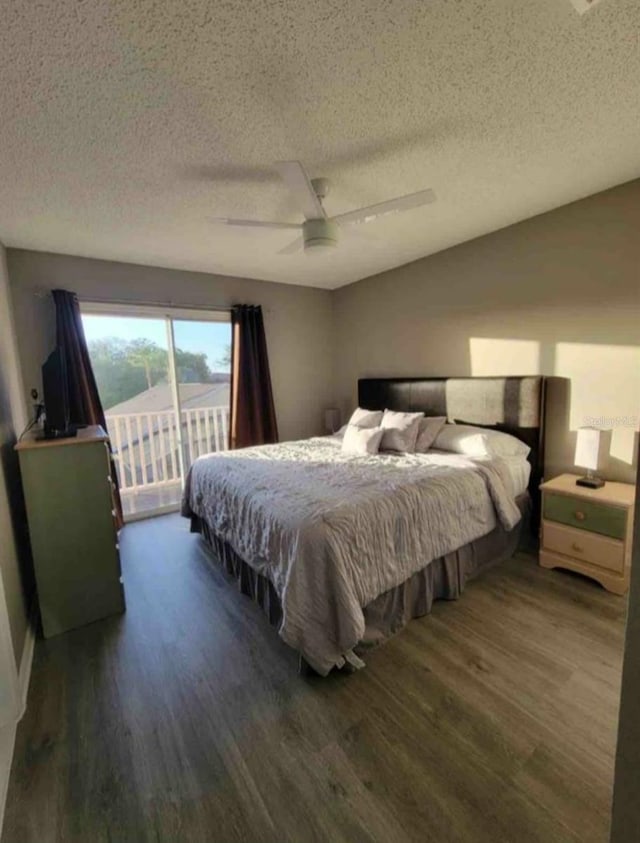 bedroom with a textured ceiling, access to outside, ceiling fan, and dark hardwood / wood-style floors