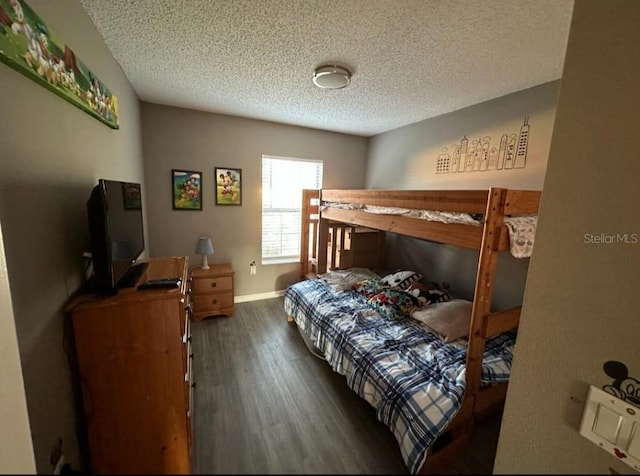 bedroom featuring dark hardwood / wood-style floors and a textured ceiling